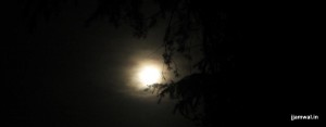 Full moon on a cloudy night in mountains